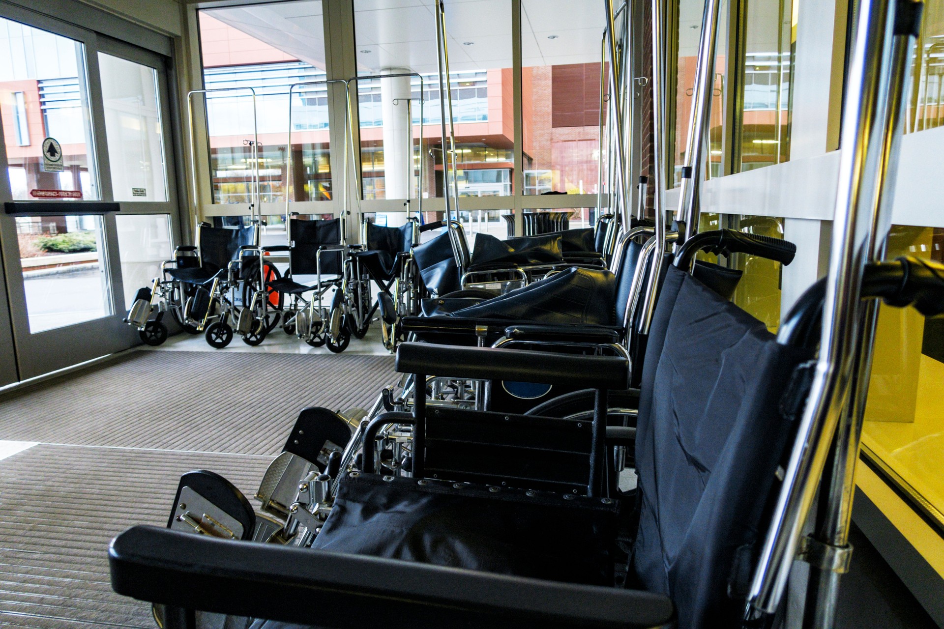 Large Group of Wheelchairs Waiting in a Hospital Entrance Lobby